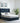 Emerson Super King Ottoman Bed with High Winged Headboard In Blue Ink Velvet